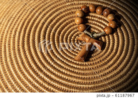 Tau - Wooden Cross and Rosary Bead on woven wicker texture Tau - Wooden Cross and Rosary Bead on woven wicker texture 61187967