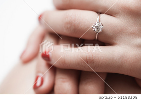 Close up of an elegant engagement diamond ring on Close up of an elegant engagement diamond ring on 61188308