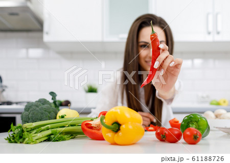 Close-up of a Chili Pepper Demonstrated to Camera Close-up of a Chili Pepper Demonstrated to Camera 61188726