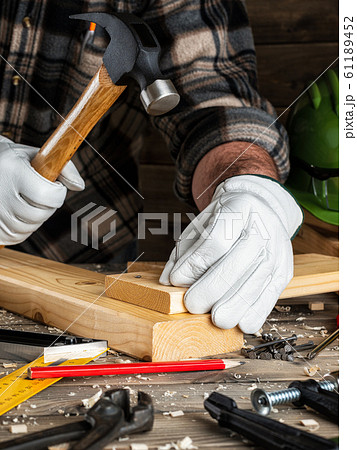 Carpenter at work on wooden boards. Carpentry. 61189452