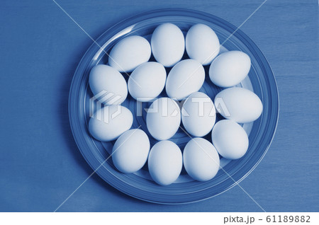 Easter eggs on colorful plate and blue background. 61189882