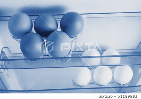 Open fridge, eggs on the shelf of refrigerator Open fridge, eggs on the shelf of refrigerator 61189883