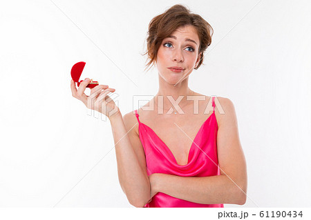 charming girl in a pink dress with a neckline thinks whether to agree or not to a wedding proposal charming girl in a pink dress with a neckline thinks whether to agree or not to a wedding proposal 61190434