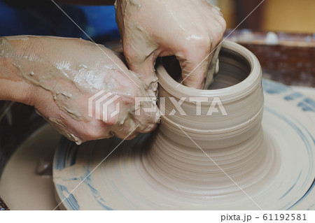 Woman hands on pottery wheel. Craftsman artist 61192581