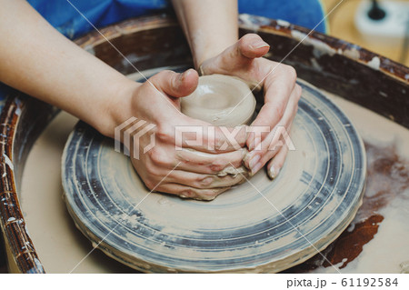 Woman hands on pottery wheel. Craftsman artist 61192584