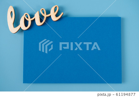 Mockup of greeting card. Blank card and inscription love on blue background. Greeting card for Valentine's Day. 61194877