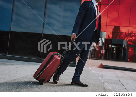 Afro American executive with suitcase outdoors stock photo 61195353