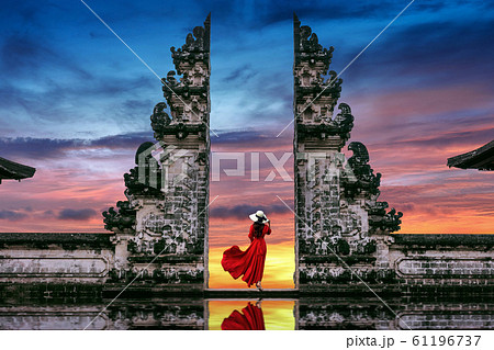 Young woman standing in temple gates at Lempuyang Luhur temple in Bali, Indonesia. 61196737