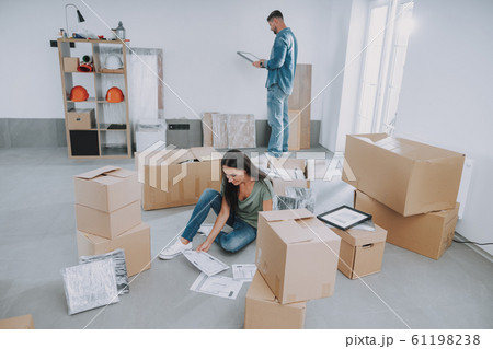 Happy young couple moving into their new home Happy young couple moving into their new home 61198238