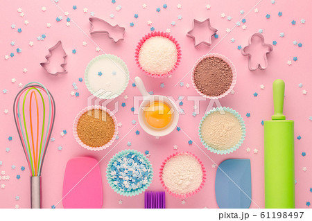 ingredients for baking and kitchen tools with cookie cutter on pink background, flat lay ingredients for baking and kitchen tools with cookie cutter on pink background, flat lay 61198497