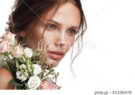 Beautiful woman with classic nude make-up, light hairstyle and flowers. Beauty face. Beautiful woman with classic nude make-up, light hairstyle and flowers. Beauty face. 61200476