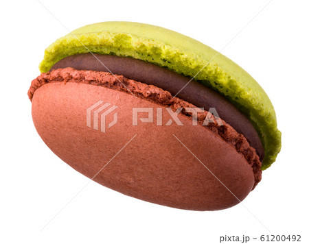 Macro photo of french caramel and pistachio macaroon isolated on white Macro photo of french caramel and pistachio macaroon isolated on white 61200492