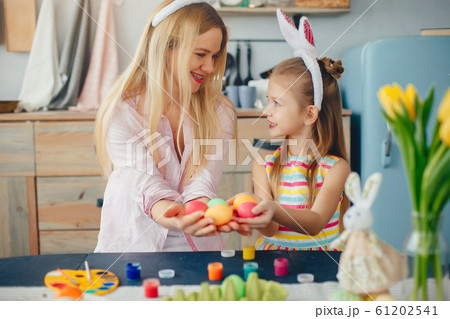Mother with little daughter in a kitchen Mother with little daughter in a kitchen 61202541