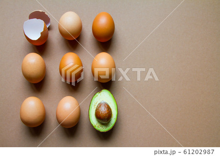 One half of row avocado, few chicken eggs and 61202987