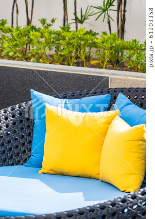 Outdoor patio in the garden with sofa chair and pillow decoration Outdoor patio in the garden with sofa chair and pillow decoration 61203358