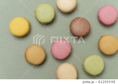 Colored tasty macaroons over a green background Colored tasty macaroons over a green background 61203548