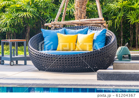 Outdoor patio in the garden with sofa chair and pillow decoration Outdoor patio in the garden with sofa chair and pillow decoration 61204367