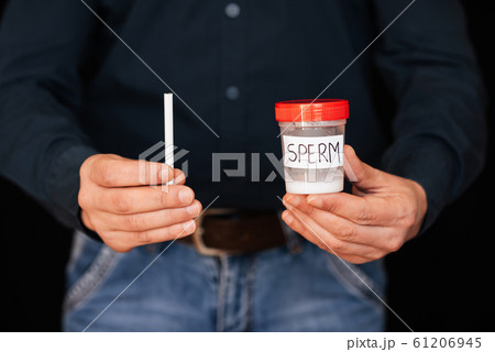 can of semen and a cigarette in the hands of a male smoker can of semen and a cigarette in the hands of a male smoker 61206945