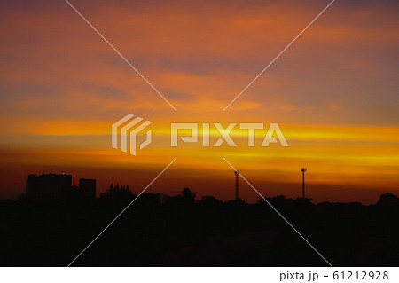 Silhouette of Beautiful sunset with television antenna or telecommunications towers have a lot of different antennas, Orange sky with sun and clouds. Nature background. 61212928