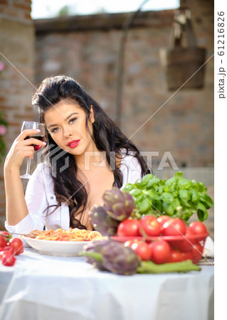 beautiful Woman in summer dress eats Italy 61216826