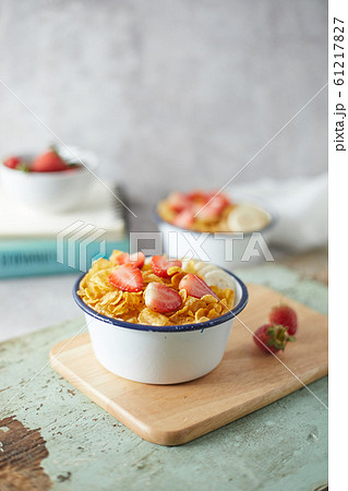 Bowl with cornflakes on background.. Bowl with cornflakes on background.. 61217827