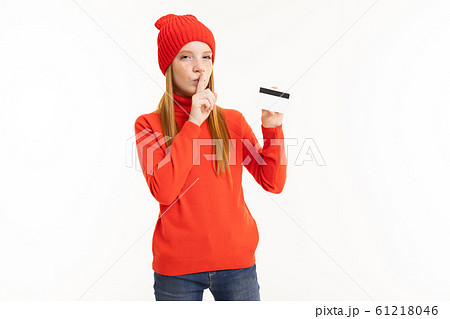 Happy teenager girl with red hair, red hoody and hat with card isolated on white background Happy teenager girl with red hair, red hoody and hat with card isolated on white background 61218046