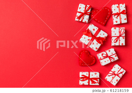 Top view of gift boxes and red textile hearts on 61218159