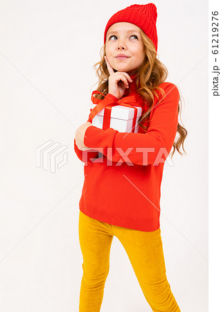 portrait of a thinking girl with a gift tied with a red ribbon on a white background portrait of a thinking girl with a gift tied with a red ribbon on a white background 61219276