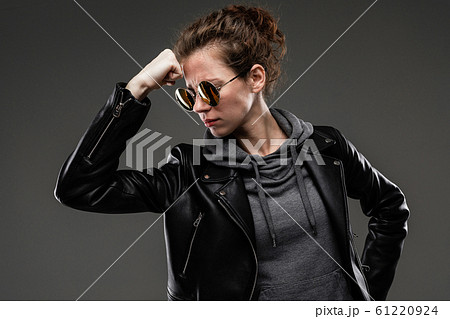 black friday concept. attractive caucasian girl in a black leather jacket and gray sweatshirt holds black friday concept. attractive caucasian girl in a black leather jacket and gray sweatshirt holds 61220924
