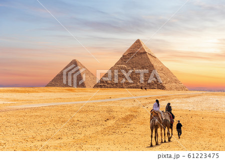 Egyptian Pyramids of Giza and the tourists on a camel Egyptian Pyramids of Giza and the tourists on a camel 61223475