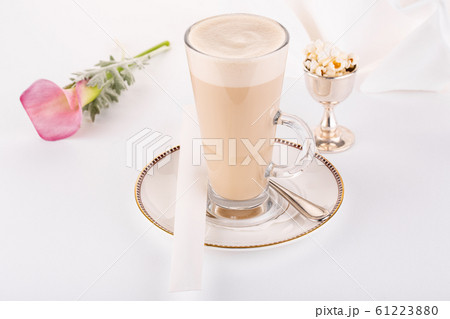 Coffee latte with popcorn and pink flower in service 61223880