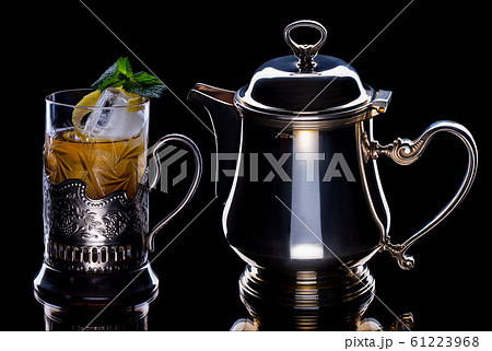 Tea with ice and mint in kettle and glass Tea with ice and mint in kettle and glass 61223968