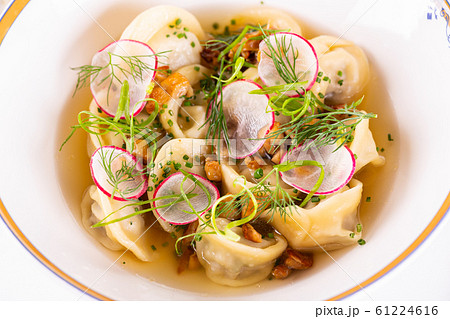 Meat broth with dumplings, radish and greens Meat broth with dumplings, radish and greens 61224616