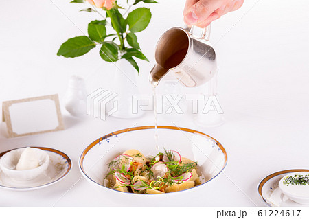 Dumplings with meat broth, served with radish and greens Dumplings with meat broth, served with radish and greens 61224617