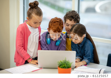 Classmates making their school project in group Classmates making their school project in group 61225057