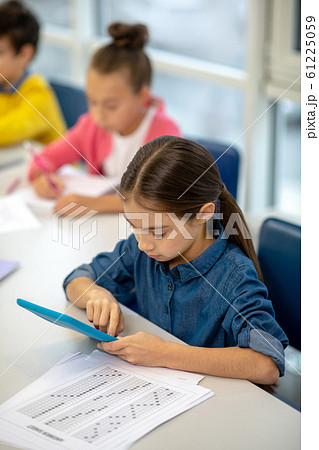 Girl working in the class using her tablet 61225059
