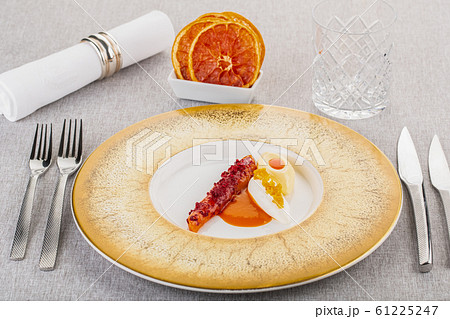 Sweet dessert with souffle and cream with pieces of caramelised orange 61225247