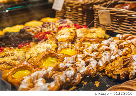 Pastry shop with variety of donuts, muffins, creme brulee, cakes with fruits and berries Pastry shop with variety of donuts, muffins, creme brulee, cakes with fruits and berries 61225610