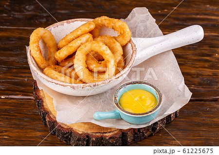 Onion rings in meatballs, served with mustard sauce Onion rings in meatballs, served with mustard sauce 61225675