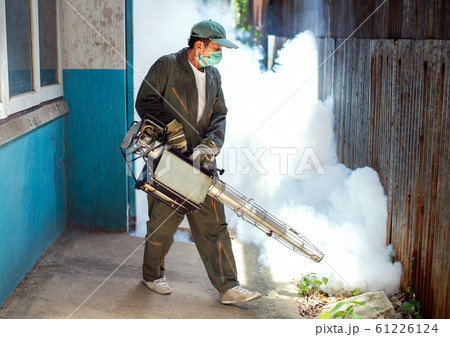 Man work fogging to eliminate mosquito for preventing spread dengue fever Man work fogging to eliminate mosquito for preventing spread dengue fever 61226124