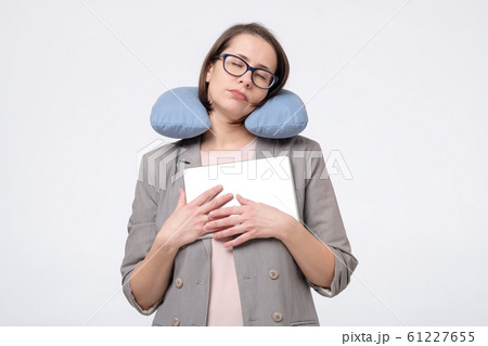 Caucasian matur woman in glasses resting with travel pillow in vacation trip Caucasian matur woman in glasses resting with travel pillow in vacation trip 61227655