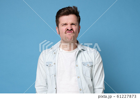 mature male student with mustache frowns face, dislikes something, looks with disgusting expression mature male student with mustache frowns face, dislikes something, looks with disgusting expression 61227873