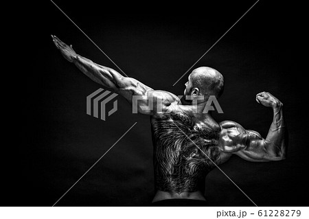 Back view of tattoed bodybuilder with outstretched arms Back view of tattoed bodybuilder with outstretched arms 61228279