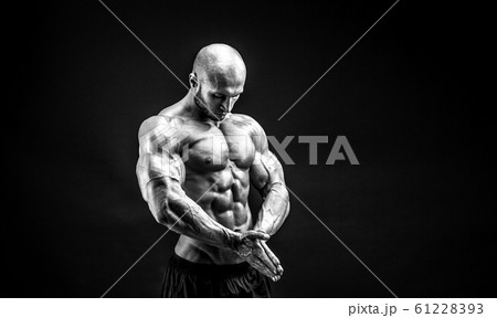 bodybuilder posing. Beautiful sporty guy male power. Fitness muscled man 61228393