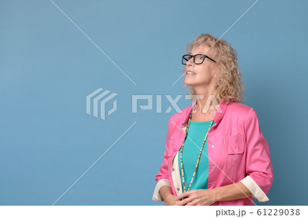 Happy dreamy middle aged senior woman looking at copy space aside. 61229038