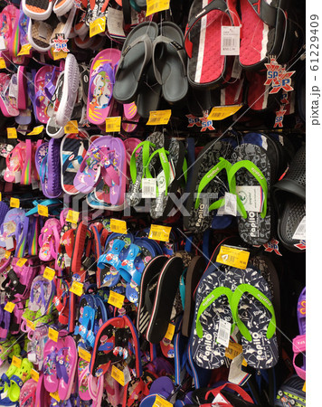 Different type of shoes and slippers piled up in one place and sell them to customers. It comes in a variety of brands, designs and sizes. 61229409