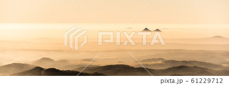 Bezdez twin mountains rising from the mist. Weather temperature inversion, Czech Republic Bezdez twin mountains rising from the mist. Weather temperature inversion, Czech Republic 61229712