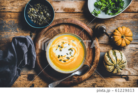 Pumpkin soup with seeds, parsley and cream in 61229813