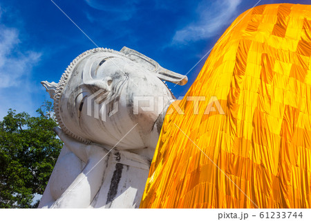 Reclining buddha statue on blue sky background Reclining buddha statue on blue sky background 61233744