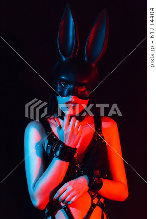 submissive girl handcuffed for BDSM sex sensually touches her finger to her lips submissive girl handcuffed for BDSM sex sensually touches her finger to her lips 61234404